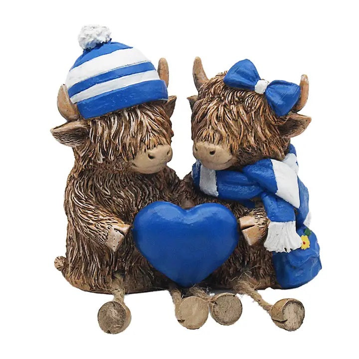 Highland Cows With Hat And Scarf Holding a Heart