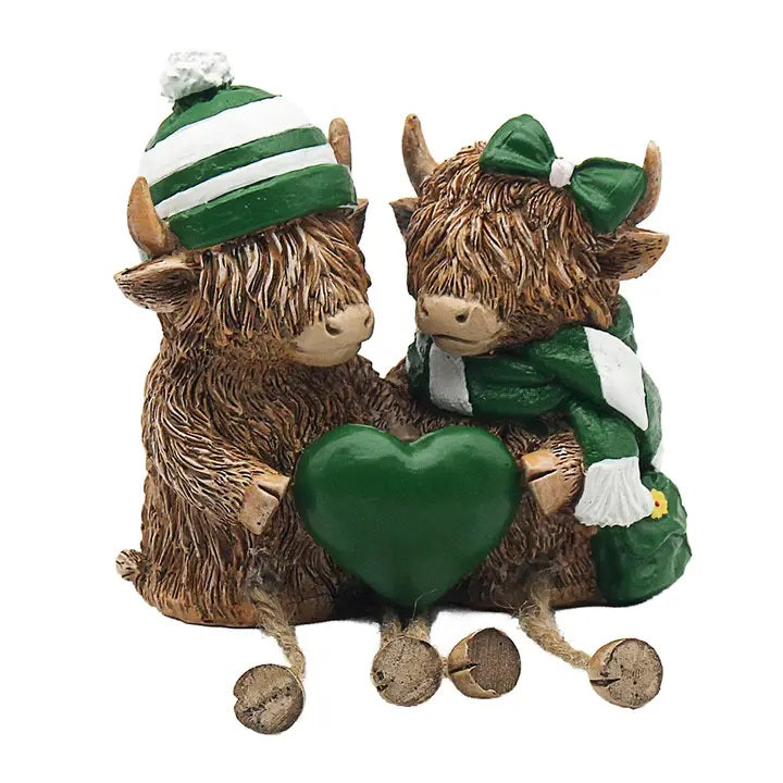 Highland Cows With Hat And Scarf Holding a Heart